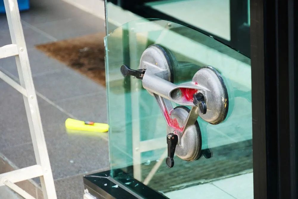 A Close Up of a Glass Clamp on a Window — Distinctive Glass & Aluminium In Port Kembla, NSW