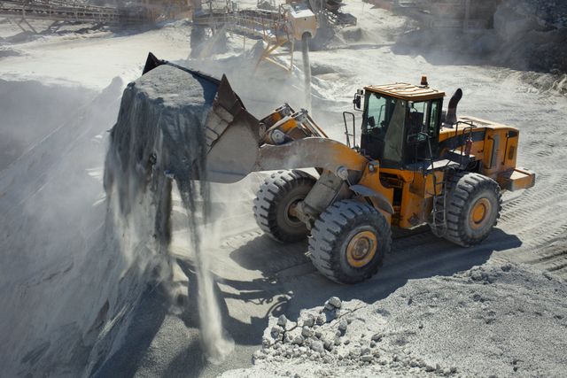 Wheel loader moving material in a quarry