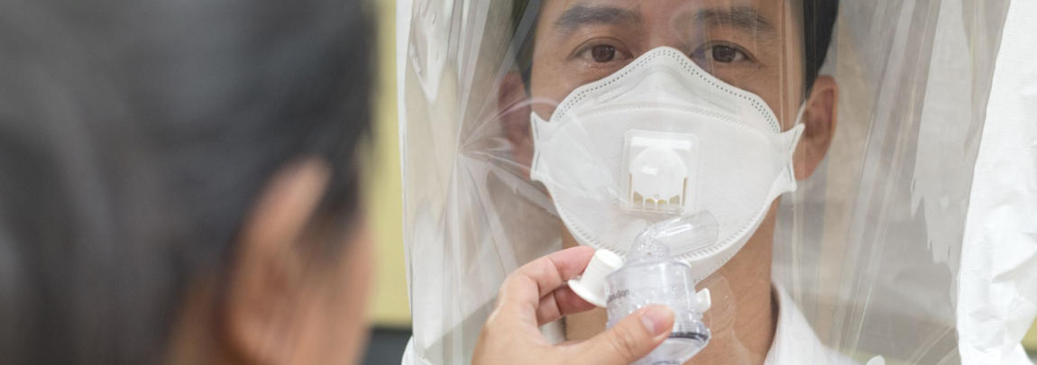 Person being fitted with a respirator mask