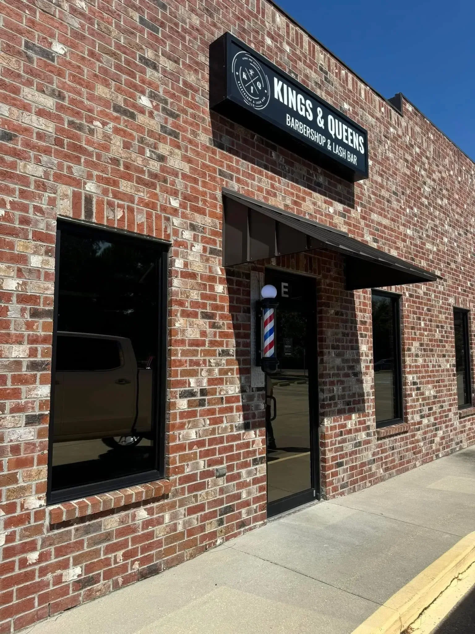 Brick building storefront with sign reading