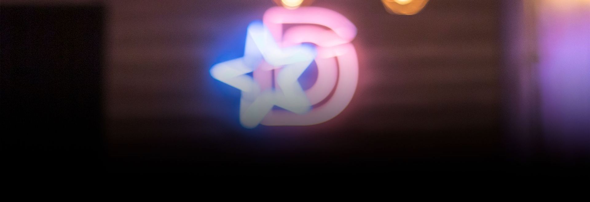 Um logotipo colorido é projetado em uma parede.