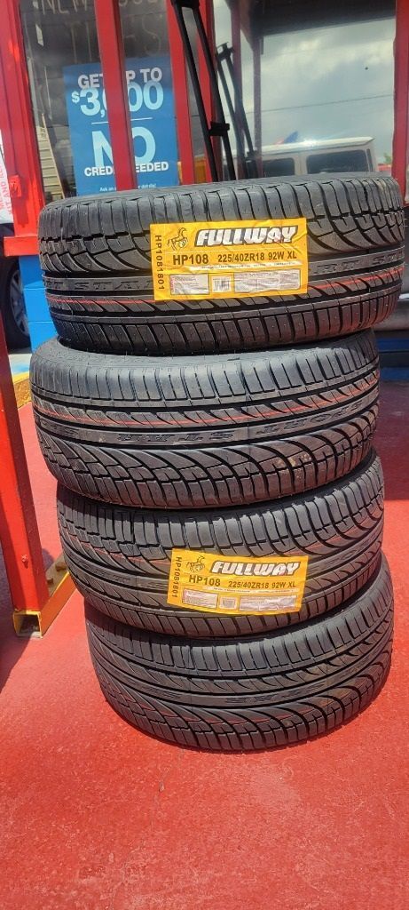 A stack of tires sitting on top of each other on a red surface.
