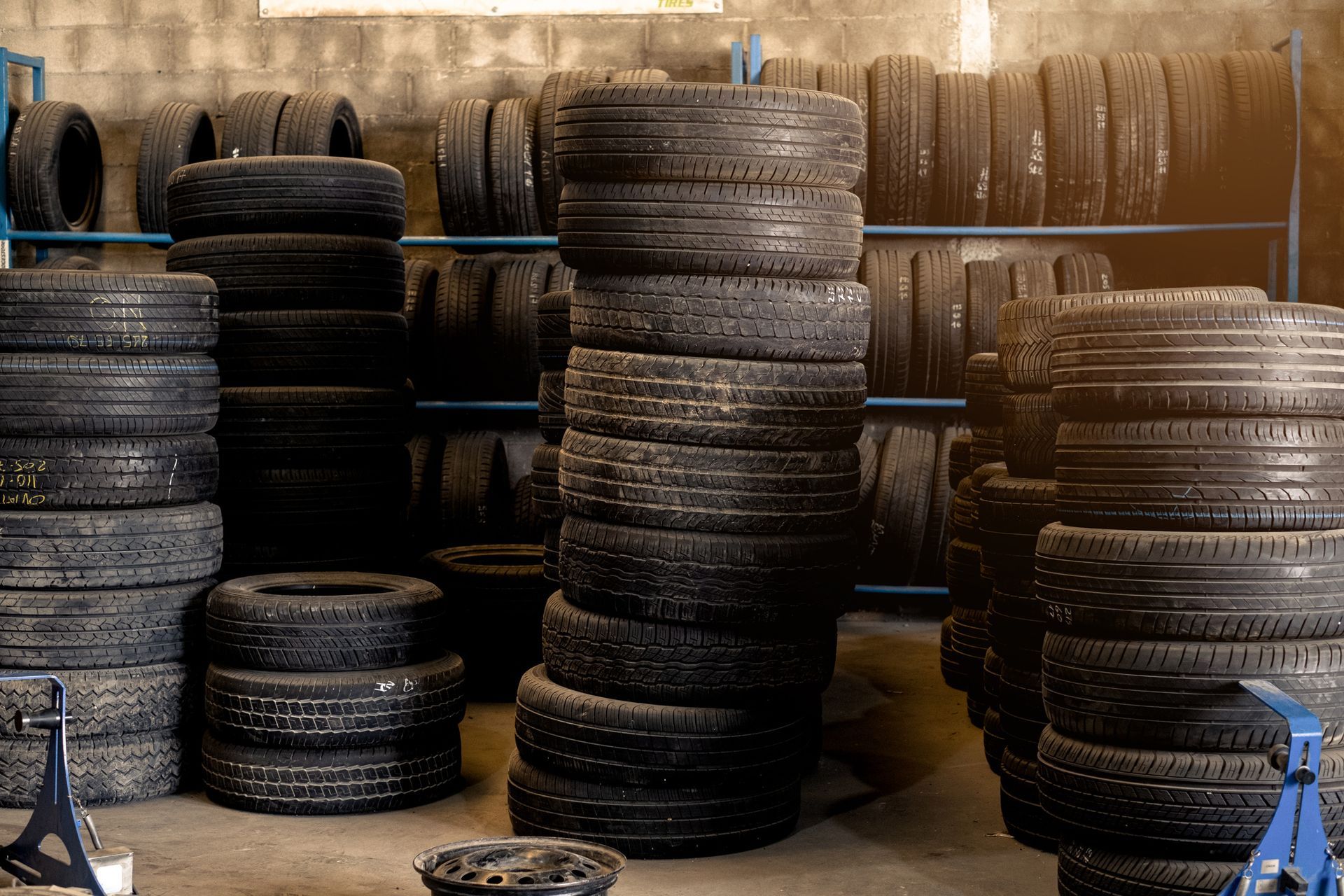 A warehouse filled with lots of tires stacked on top of each other.