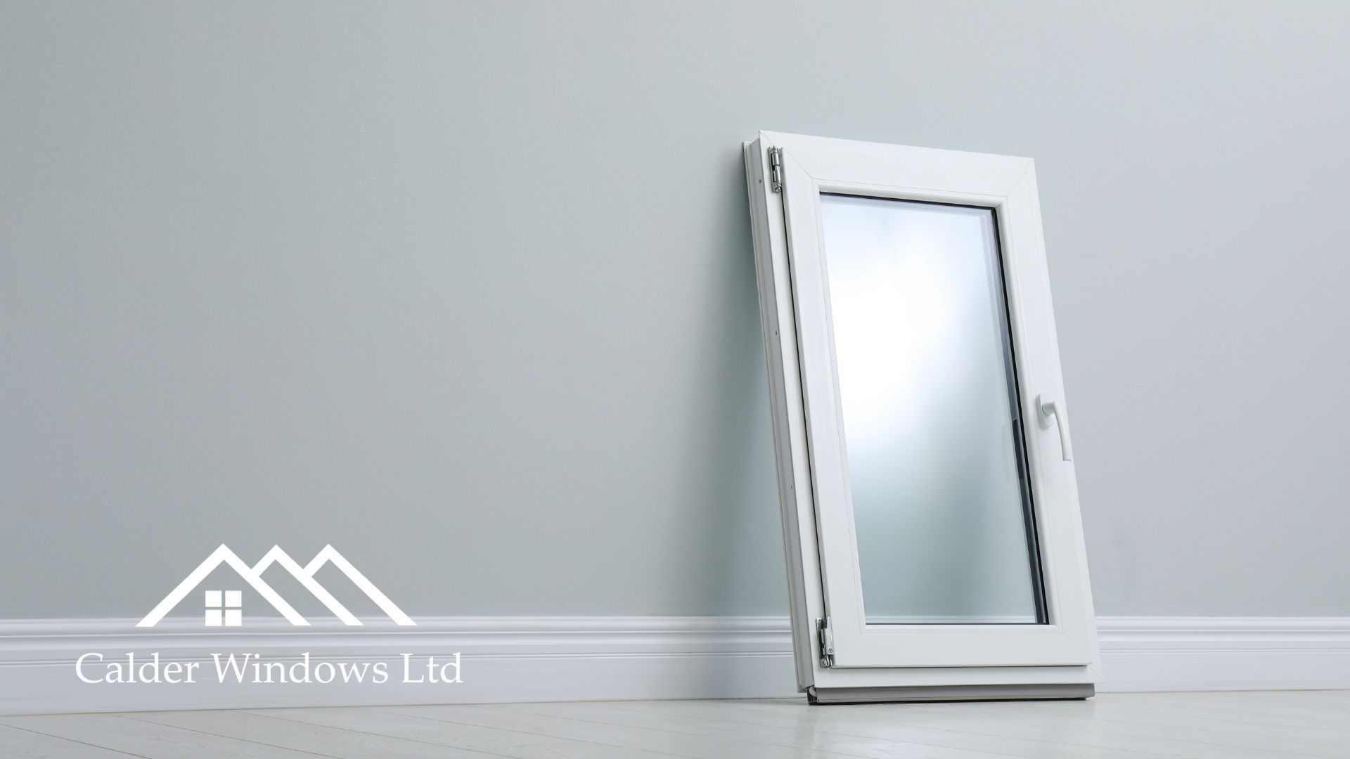 White framed mirror leaning against a light gray wall and baseboard on a minimal interior floor.