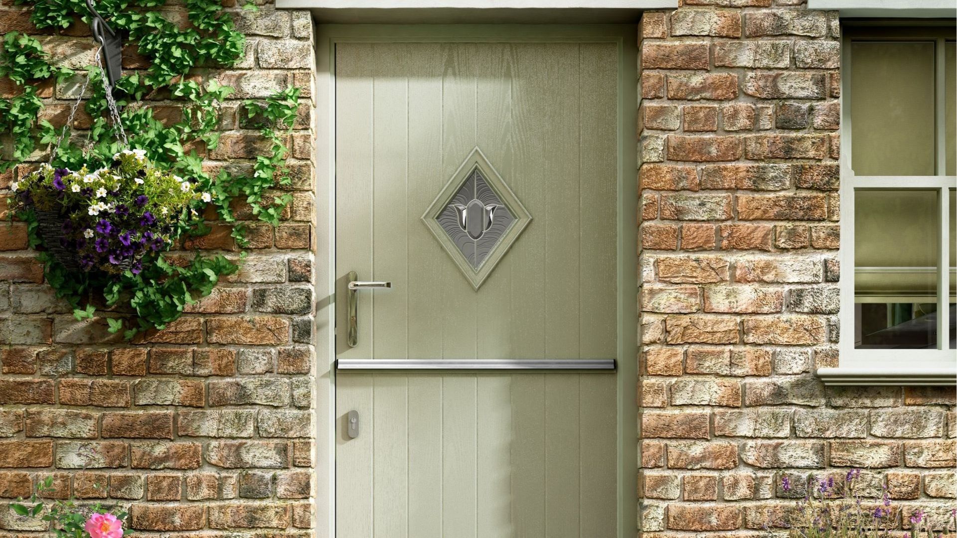 Beige front door with diamond window in a brick house wall, beside a small window and climbing flowers