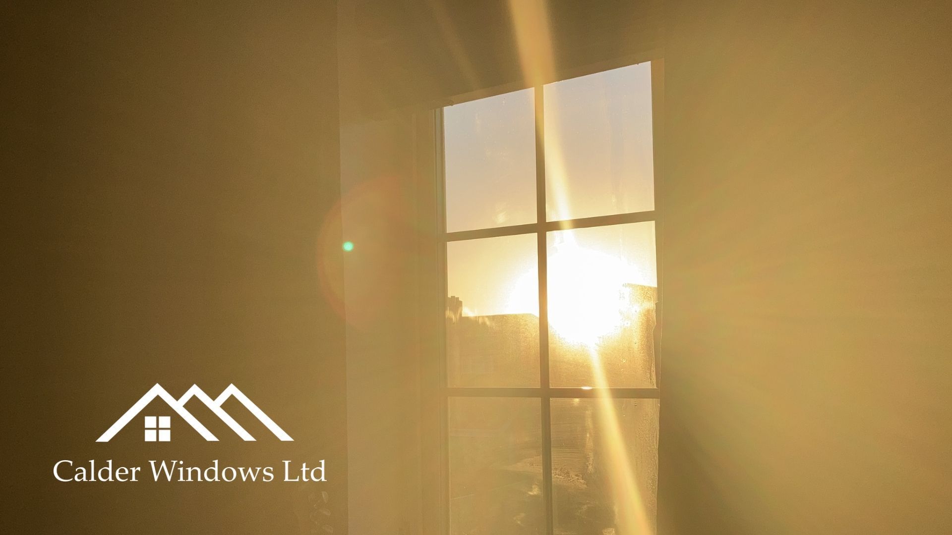 Sunlit window with warm golden light and visible logo for Calder-Hudson Ltd.