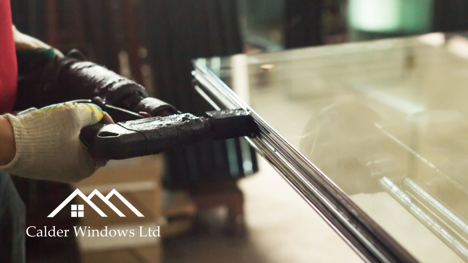 Hands wiping a glass window with a squeegee and cleaning cloth, with a building logo in the corner
