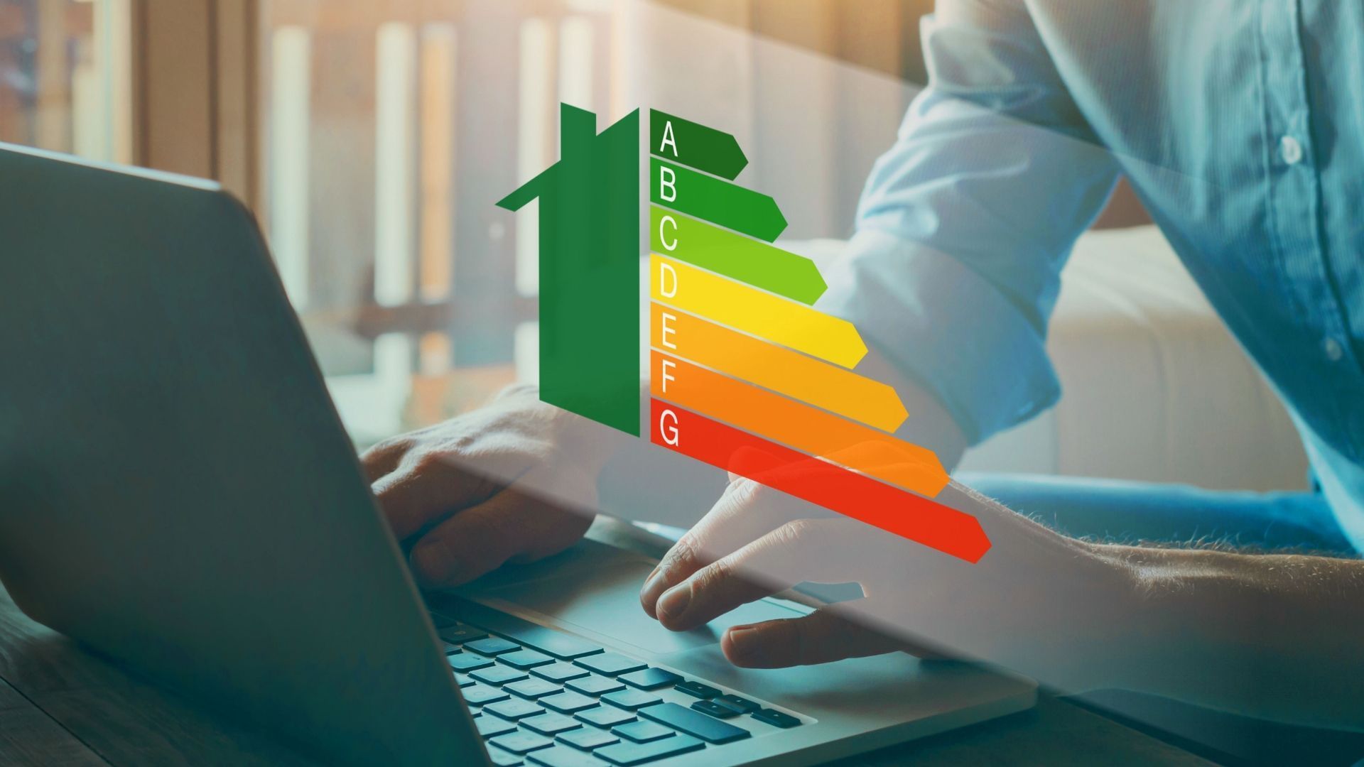 Laptop with colorful energy efficiency bars over hands typing at a desk