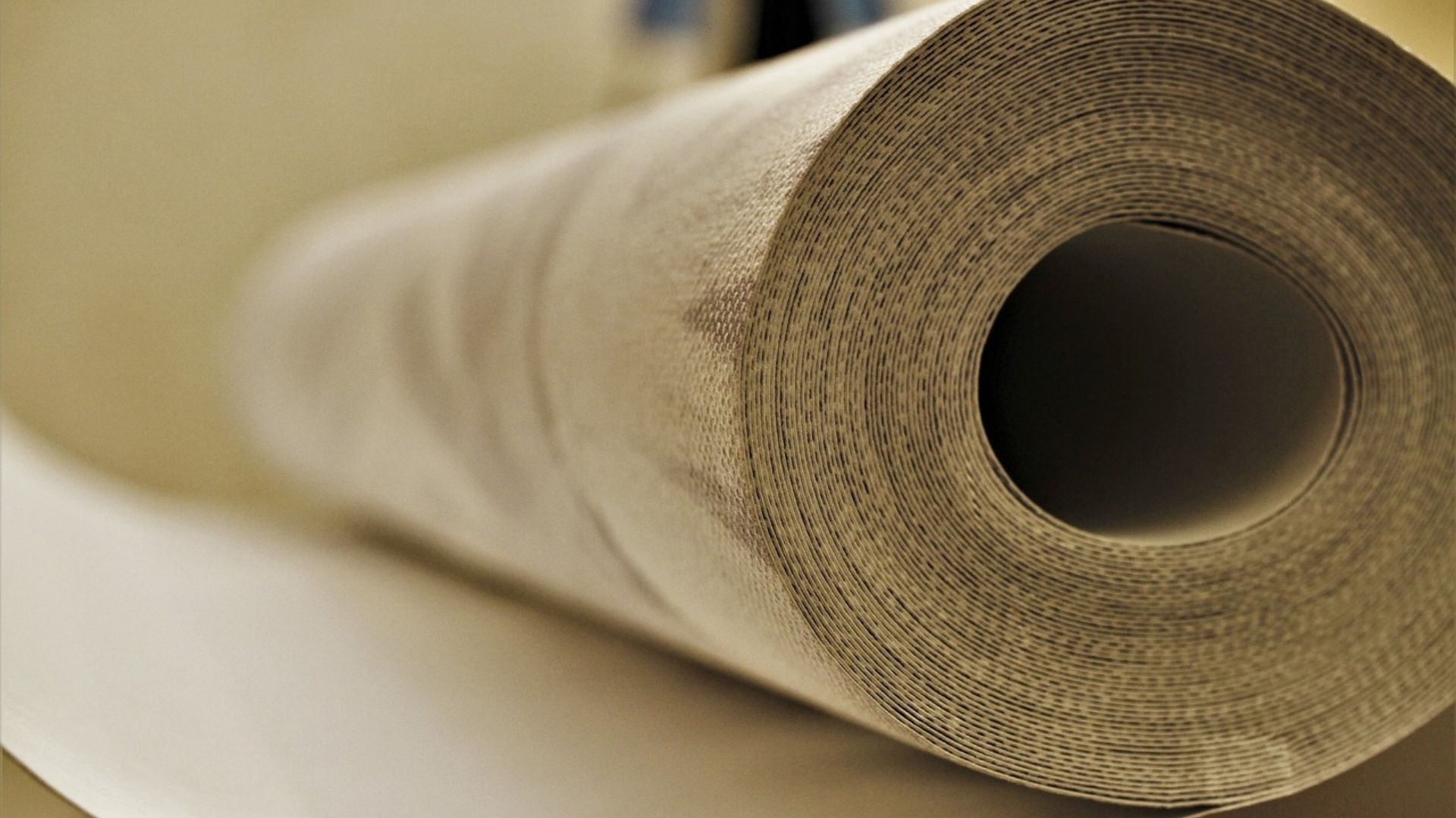 Rolled beige fabric or paper with a hollow center close-up