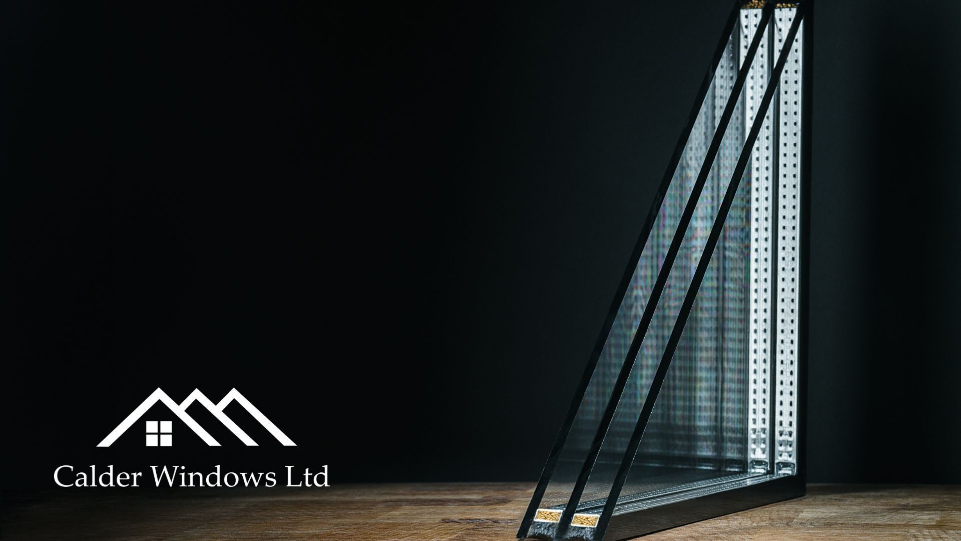 Modern glass staircase with black metal supports and the Cadde Windows Ltd logo on a dark background