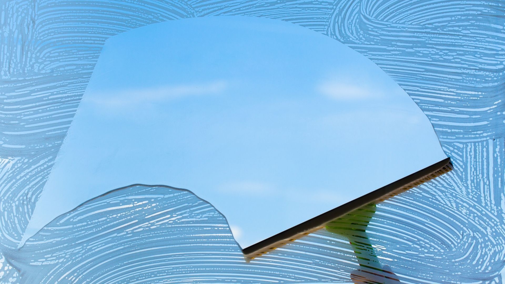 Blue cloud-shaped object with a brown edge held over a light blue patterned background