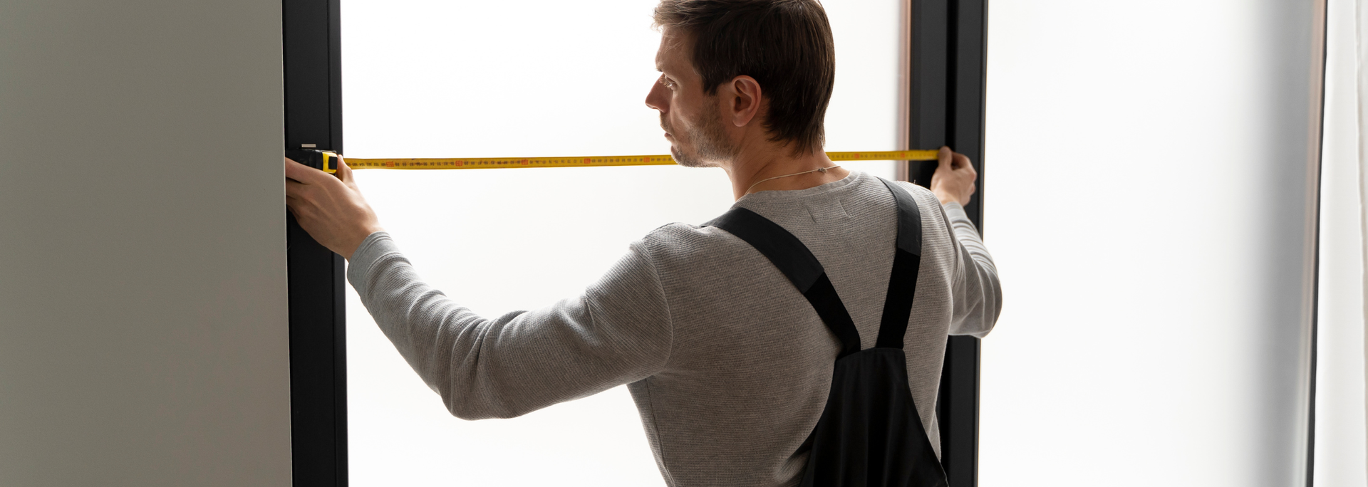 Picture of someone measuring a window. Picture of someone measuring a window.