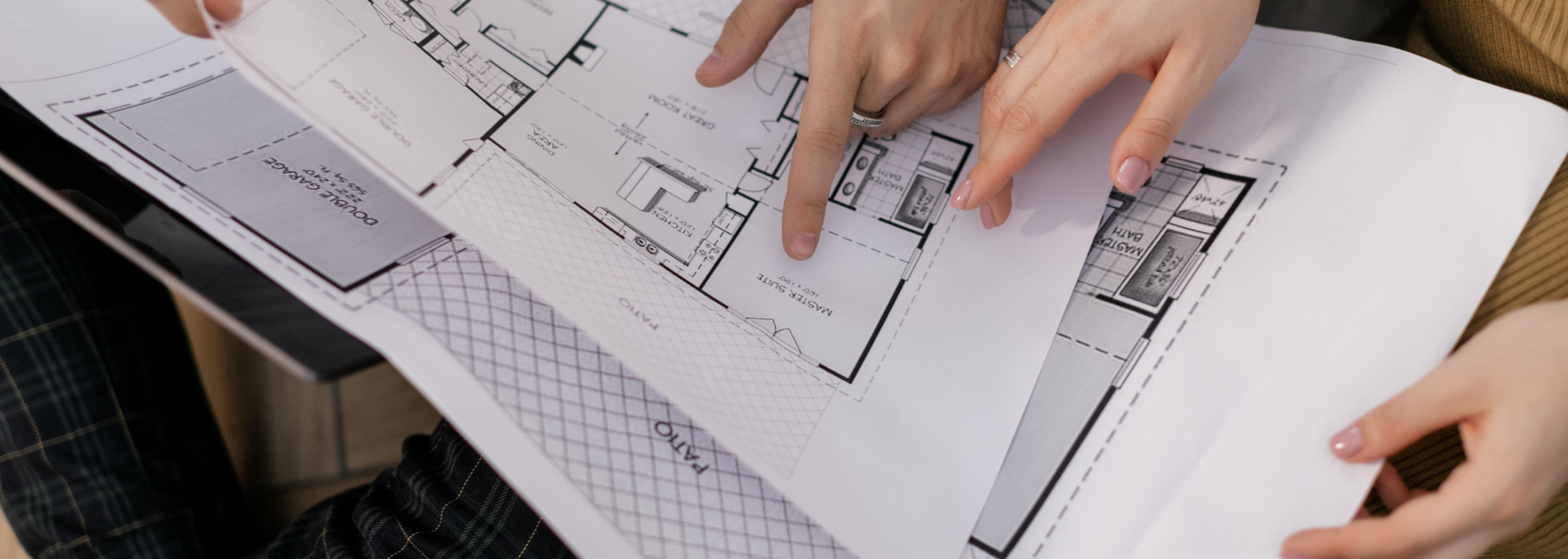 Picture of people looking at a floorplan. 