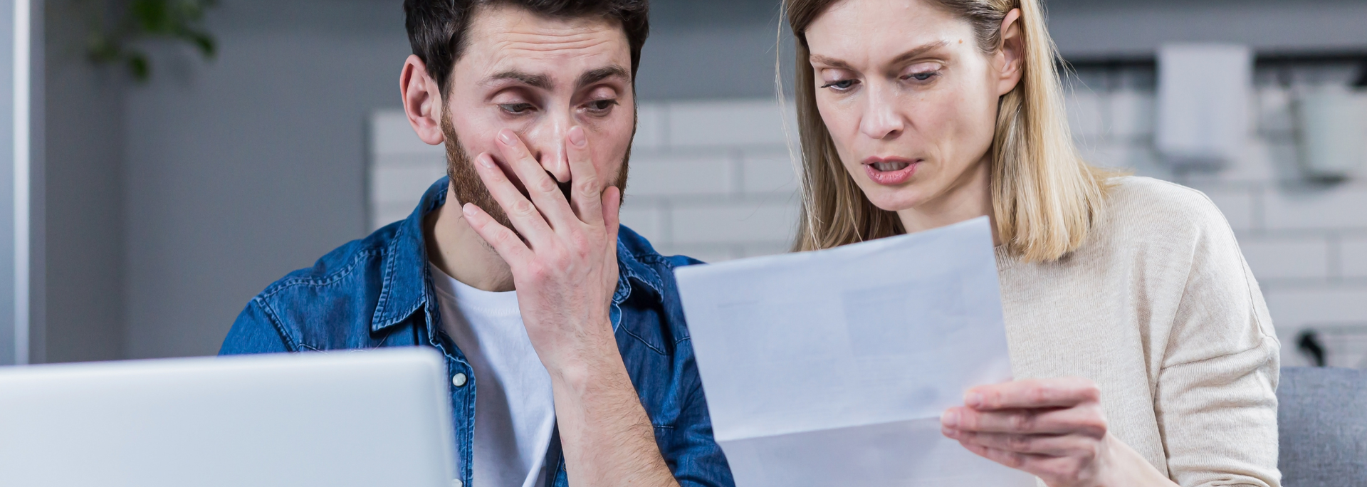 Picture of a couple looking shocked at a contract. Picture of a couple looking shocked at a contract.