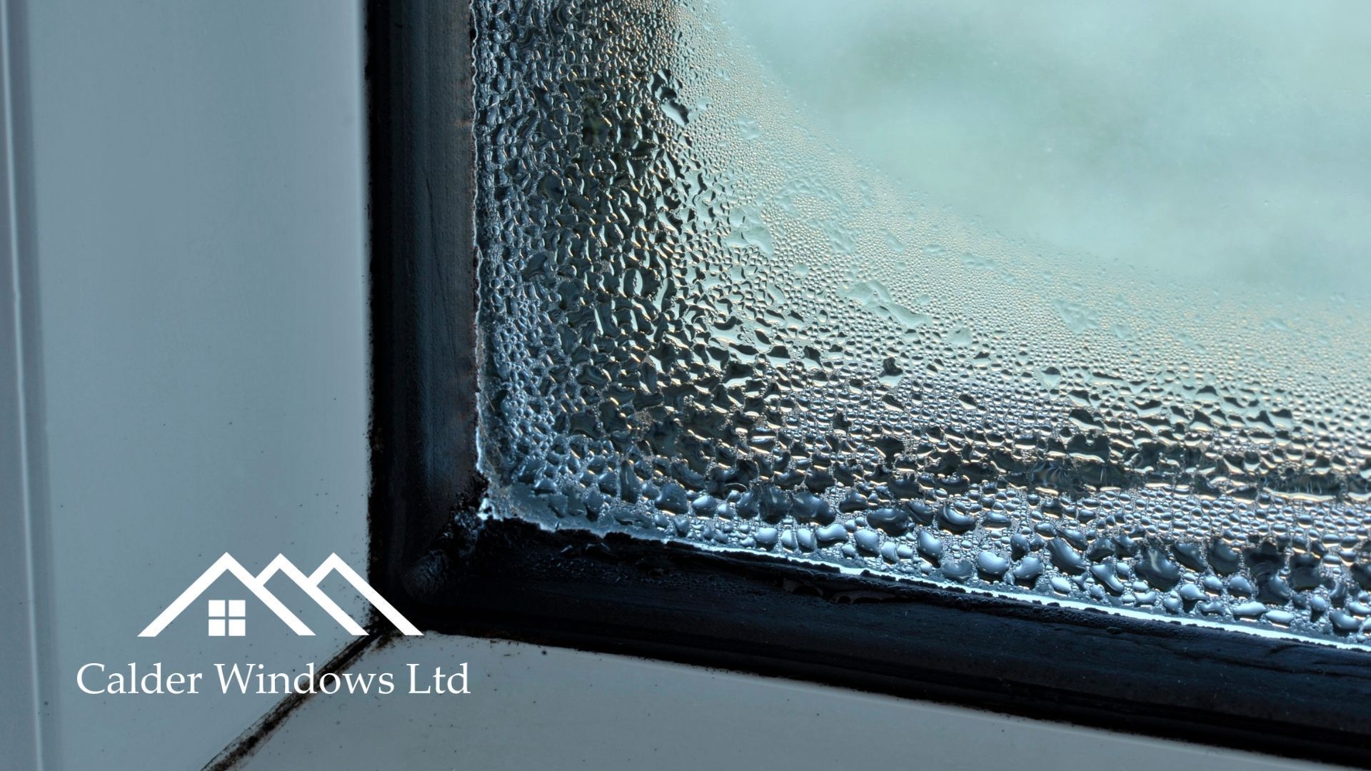 Close-up of frosted glass window with dark frame and condensation