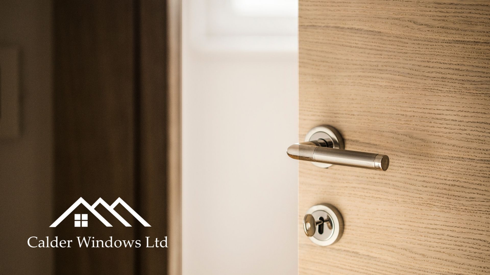 Close-up of a wooden door with a silver handle and lock, next to the Calder Windows Ltd logo.
