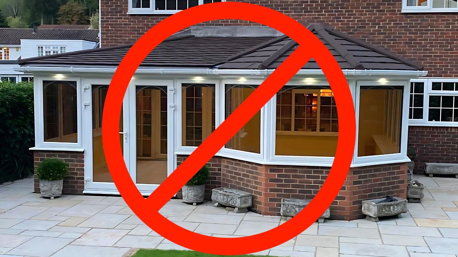 Brick house with a large red prohibition symbol over the front porch