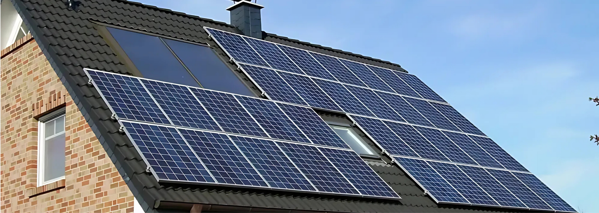 Solar panels mounted on a house roof under a blue sky