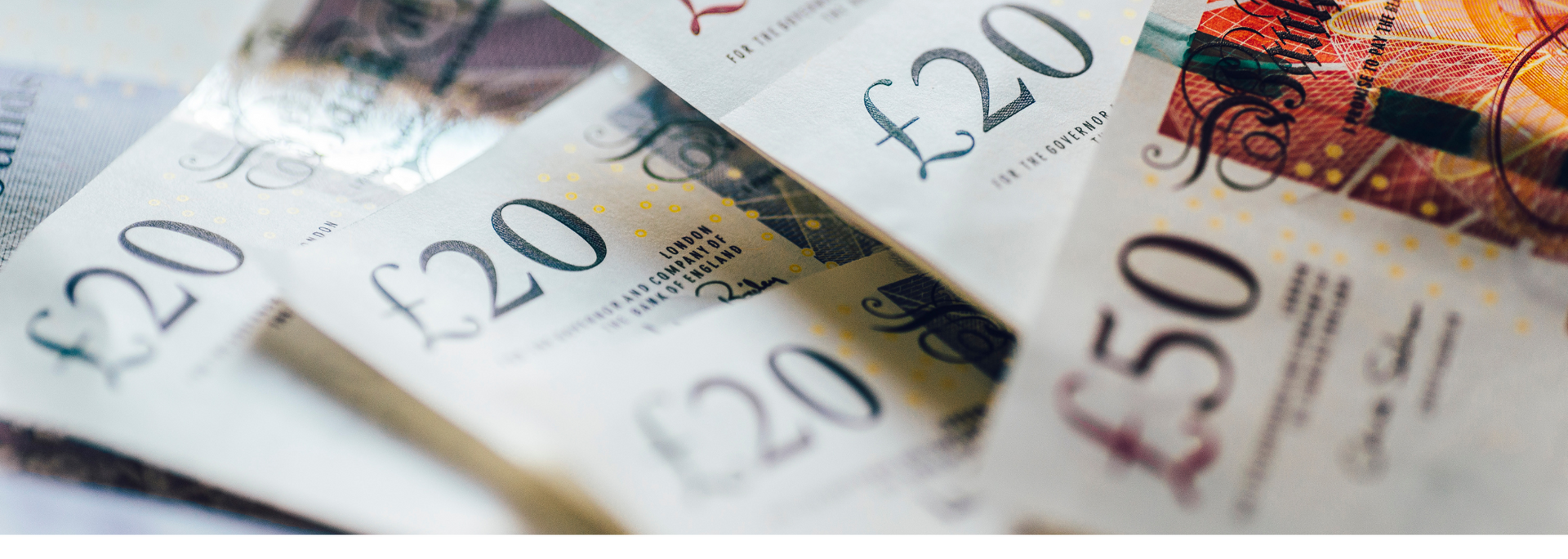 British pound banknotes fanned out, including £20 and £50 notes