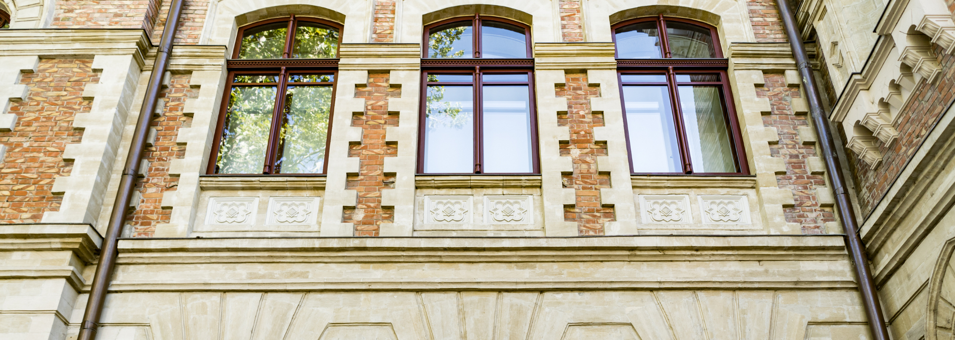 Ornate brick building facade with arched windows and decorative stone trim