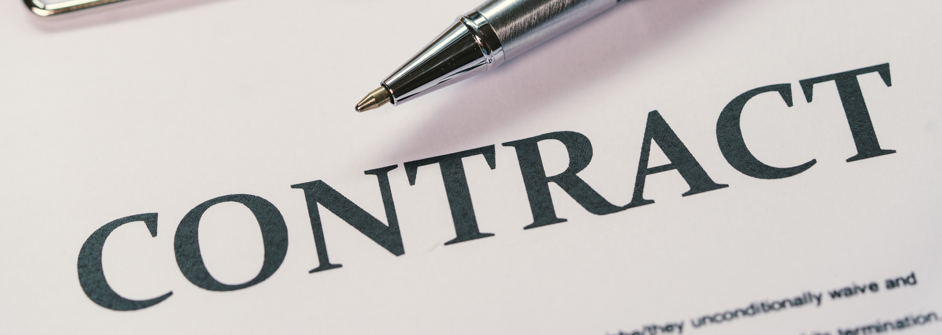 Contract document with a pen resting on it
