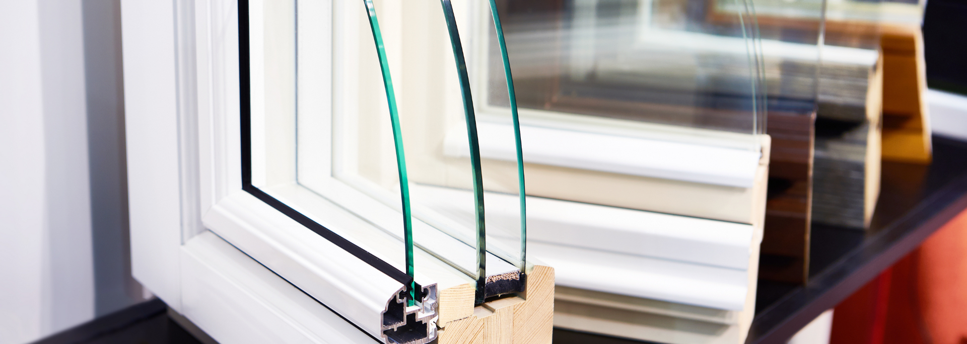 Close-up of a window frame with glass panes and a small pulley mechanism in the corner