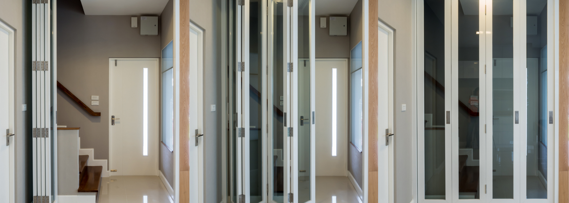 Modern hallway with glass doors, beige walls, stairs, and a front door at the end