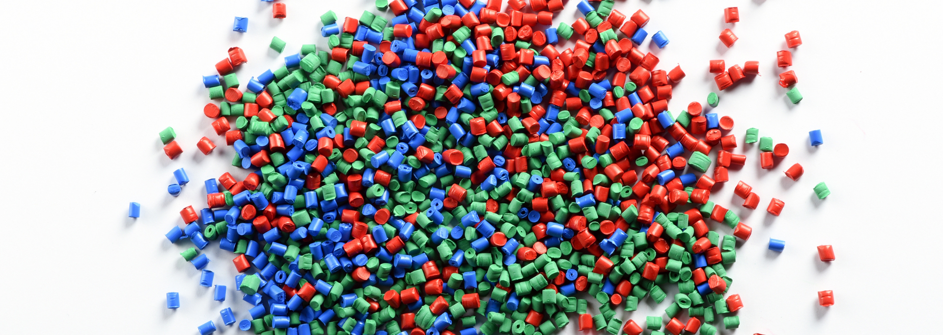 Heap of multicolored candy-coated chocolates scattered on a white background
