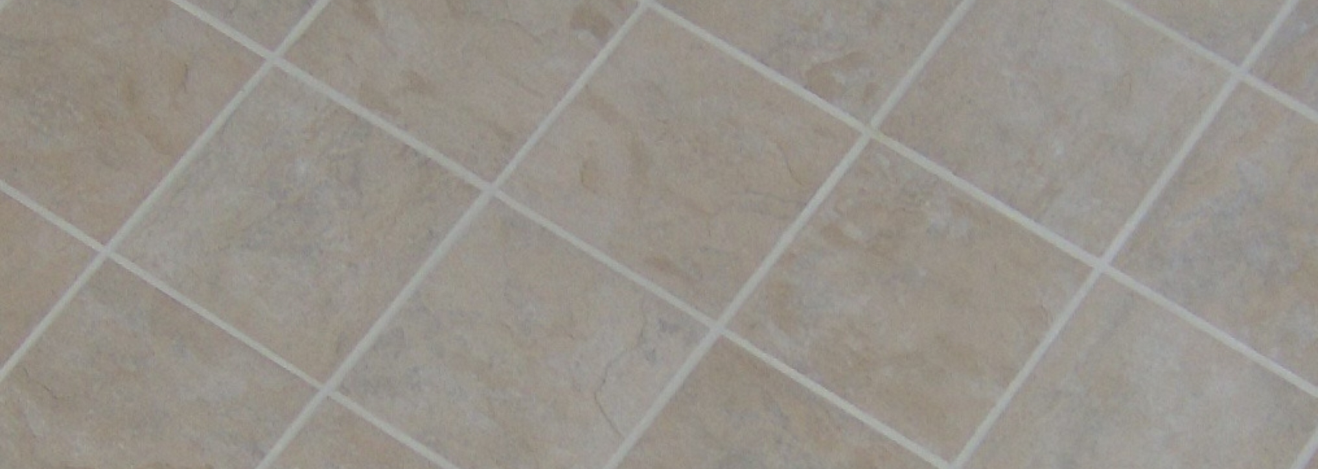 Beige tiled floor with diagonal grout lines and subtle white veining