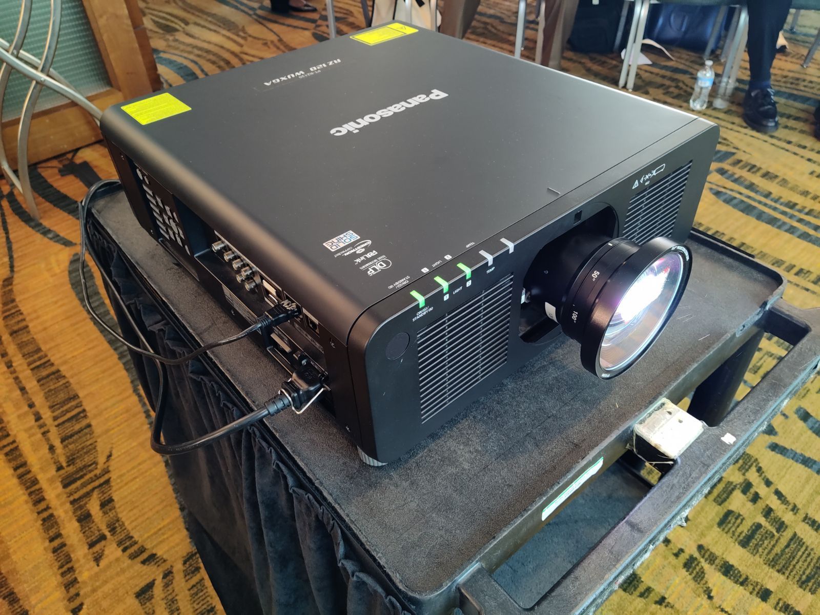 A panasonic projector is sitting on top of a table