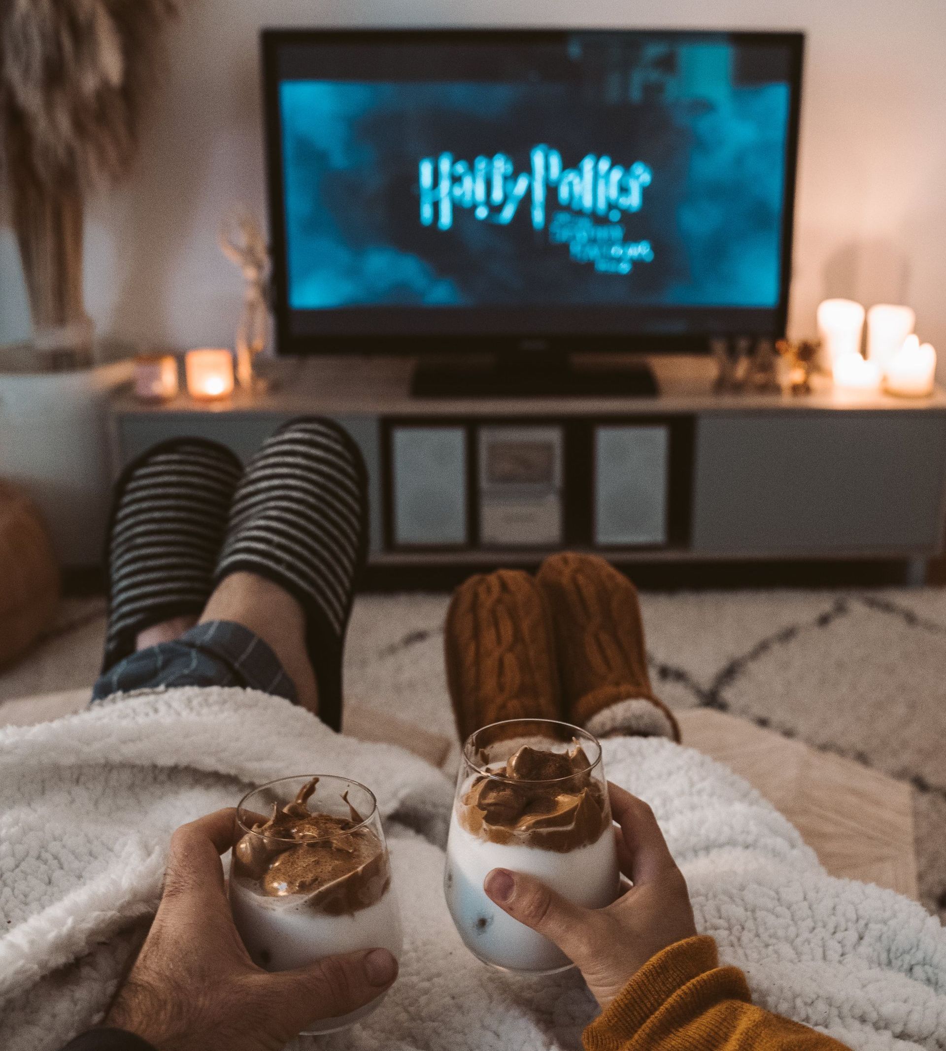 a person is sitting in front of a television watching harry potter