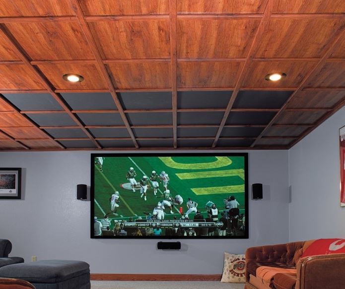 Home theater with a large screen, wood ceiling, and a football game playing.