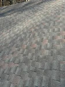 Gray shingled roof with a slight slope, viewed close up from above