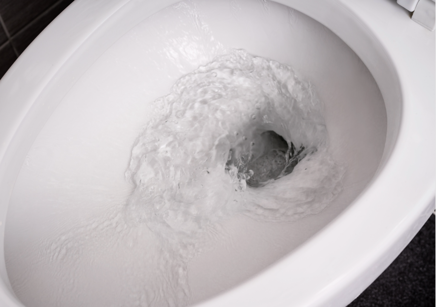 Image of the inside of a toilet while it is flushing.