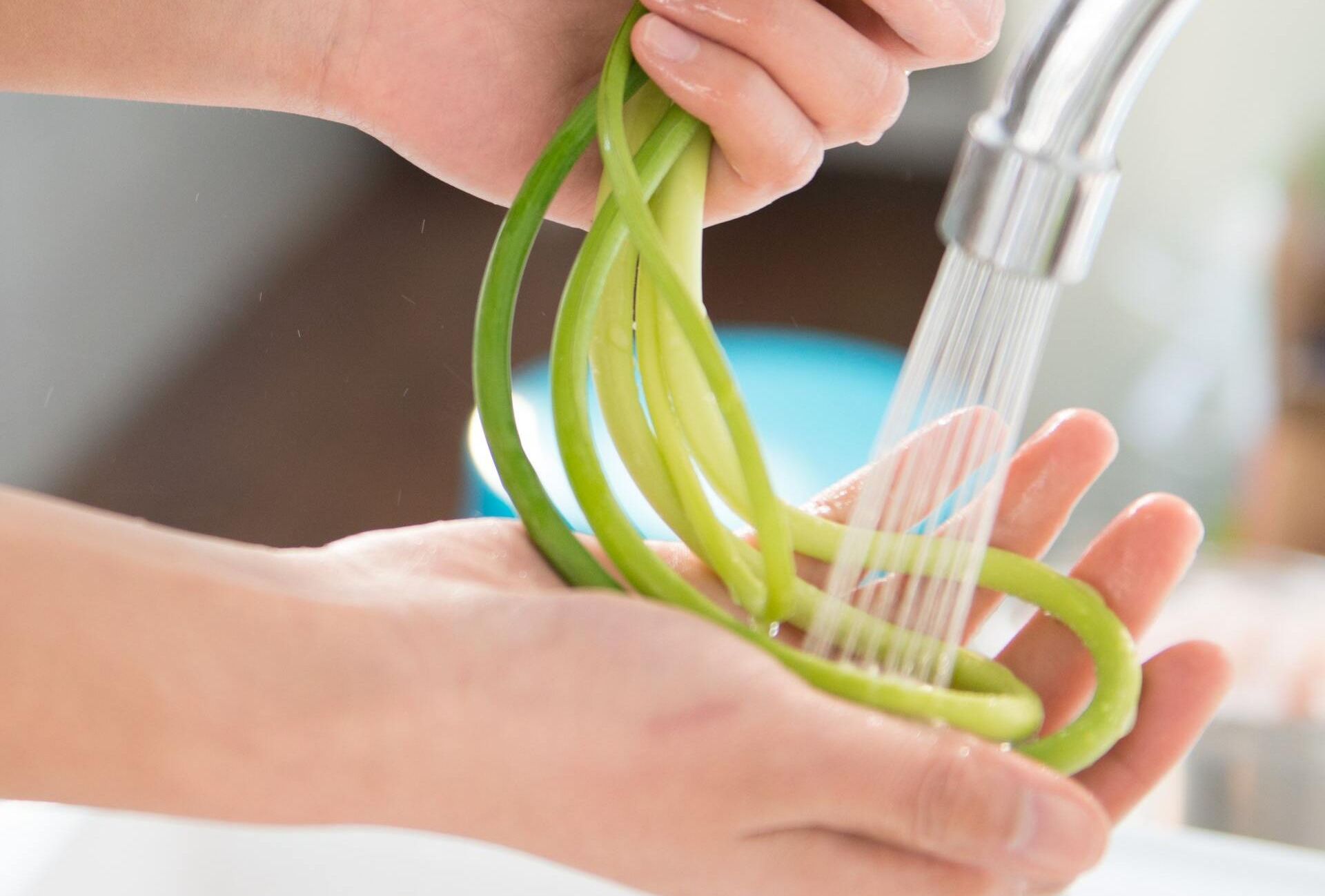 Person washing vegetables