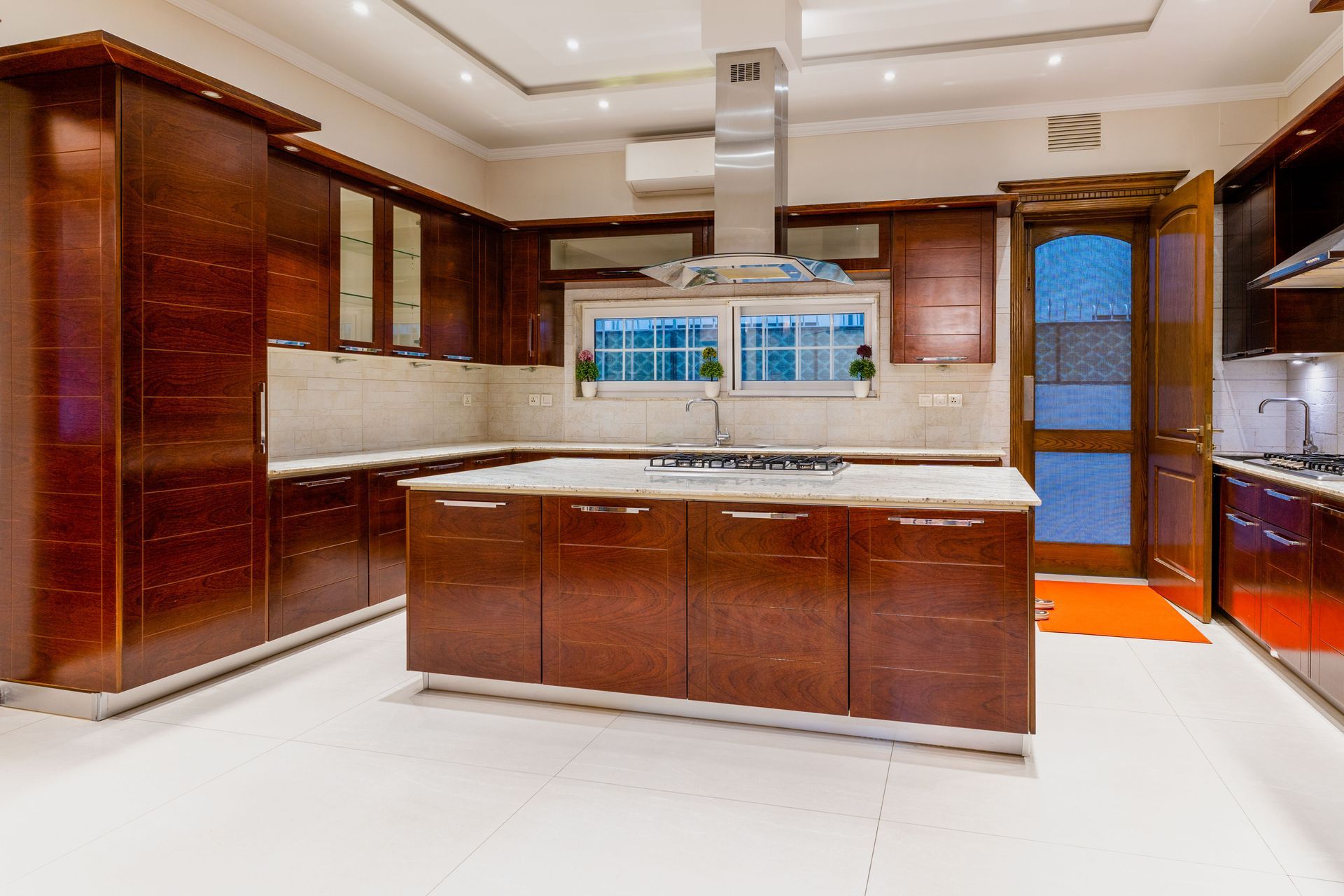 A modern bathroom with dark tiled features, a floating vanity, modern furnishings, and custom lighting throughout.