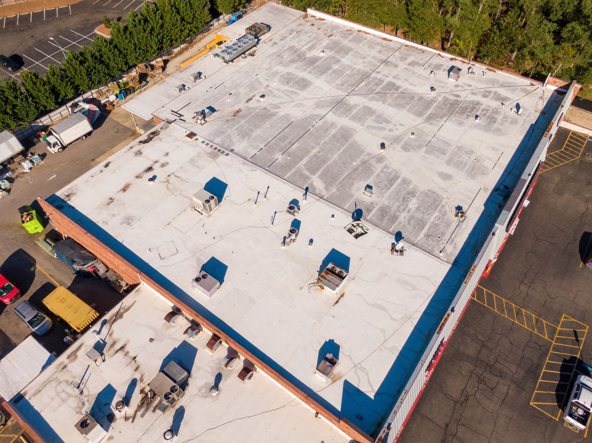 Aerial view of a large commercial building roof with vents and HVAC units installed.