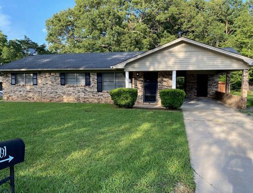 A brick house with a mailbox in front of it.
