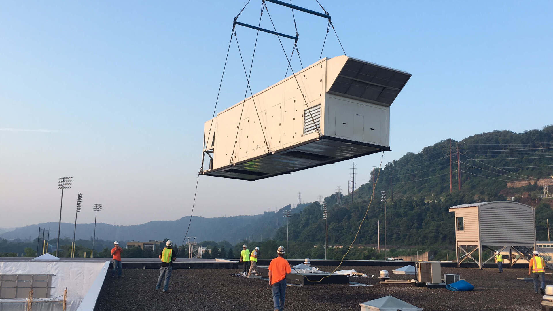 DOAS unit on a crane being lifted