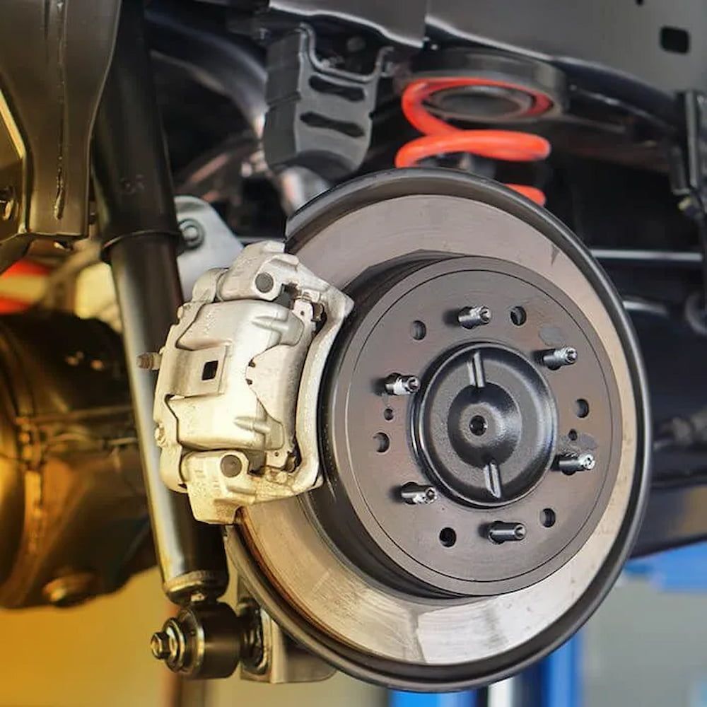 A Car's Brake System On A Lift — Figtree Brake and Clutch in Figtree, NSW