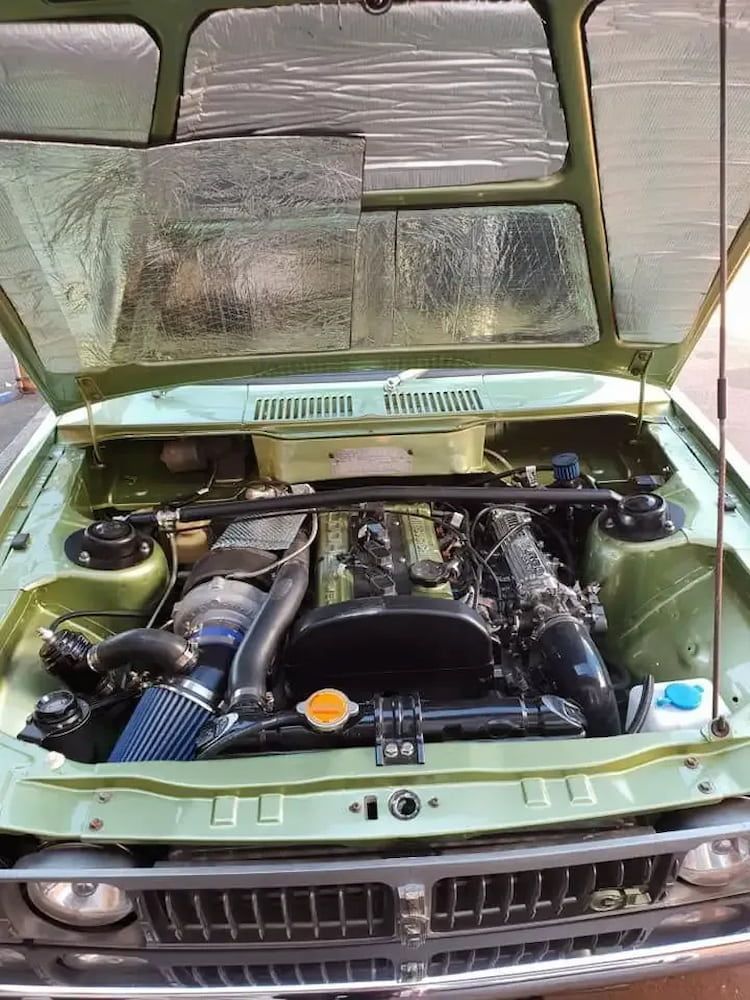 The Hood Of A Green Car Is Open And Shows The Engine — Figtree Brake and Clutch in Coniston, NSW