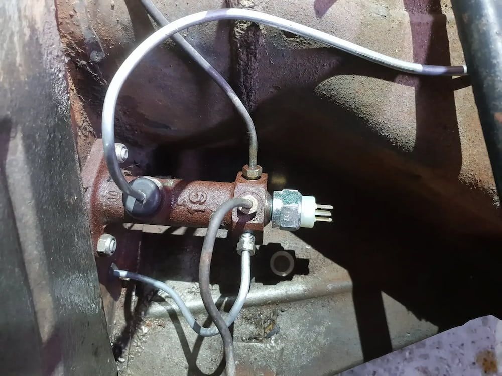 A Brake Cylinder With A Hose Attached To It — Figtree Brake and Clutch in Coniston, NSW