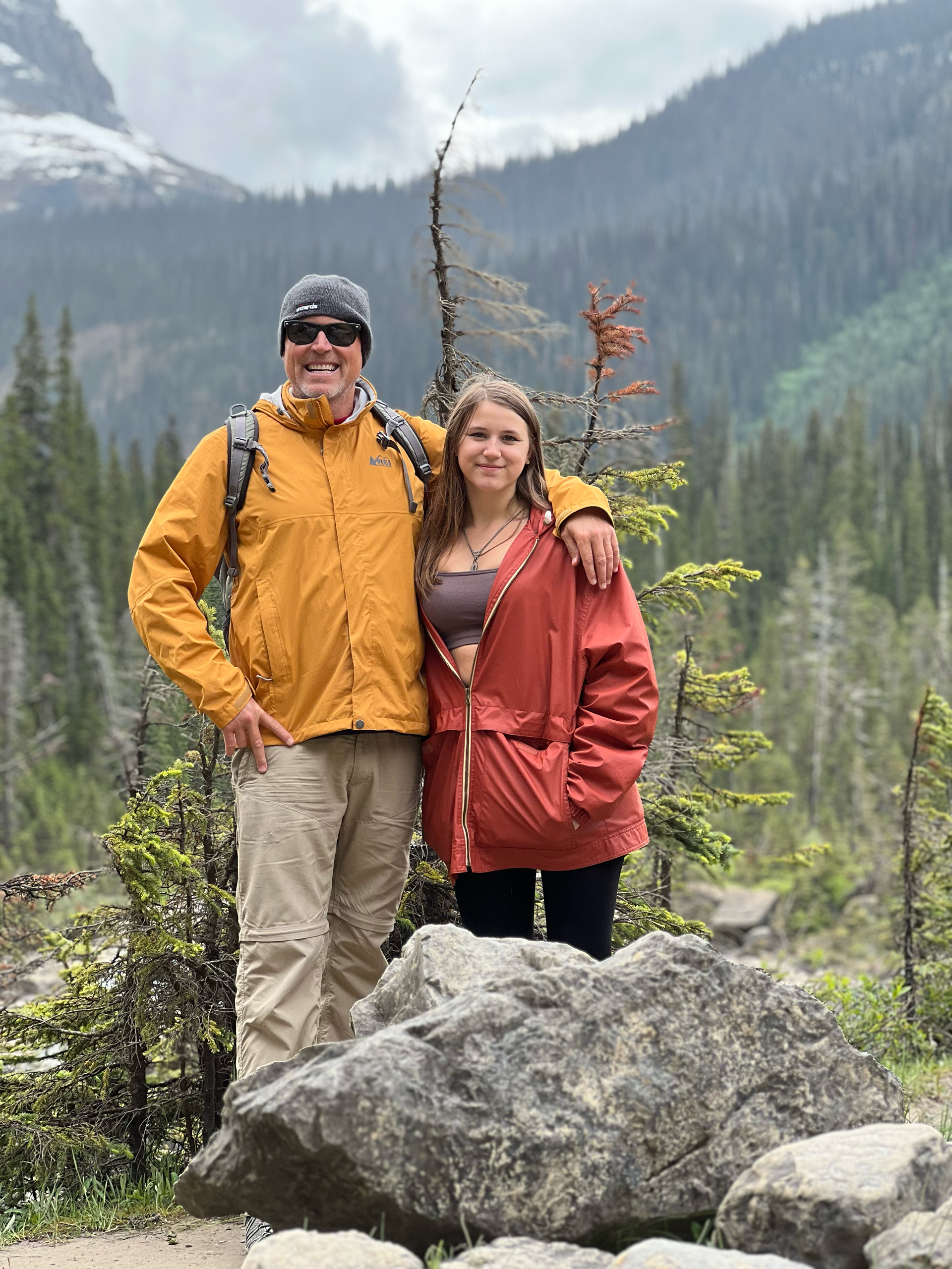 John and Nathalie are posing for a picture in front of a mountain on Plain of Six Glaciers hike.