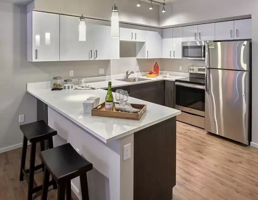 A kitchen with white cabinets and stainless steel appliances