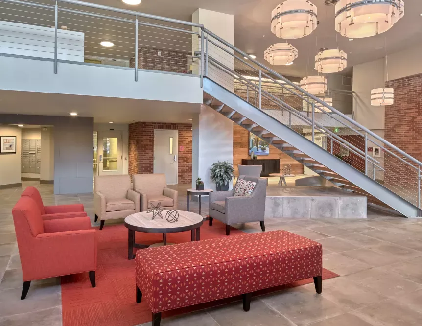 A lobby with stairs leading up to the second floor