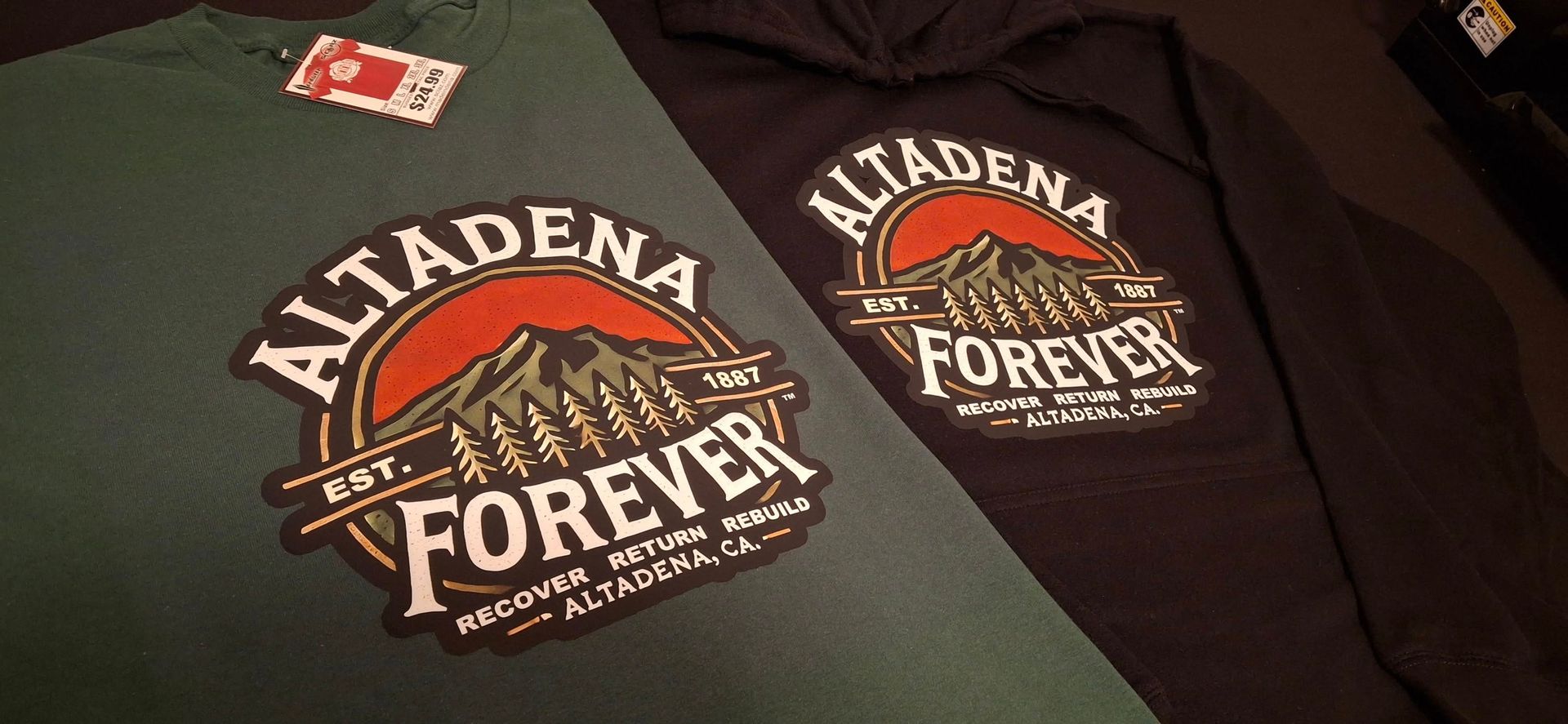 Two shirts with the words altadena forever on them are sitting on a table.