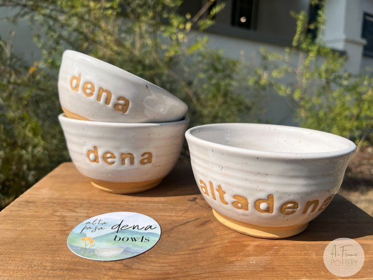 Three bowls are stacked on top of each other on a wooden table.