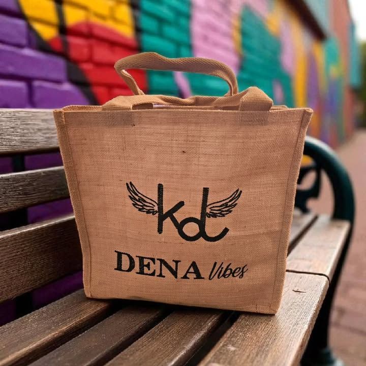 A tan burlap tote bag with the black text 