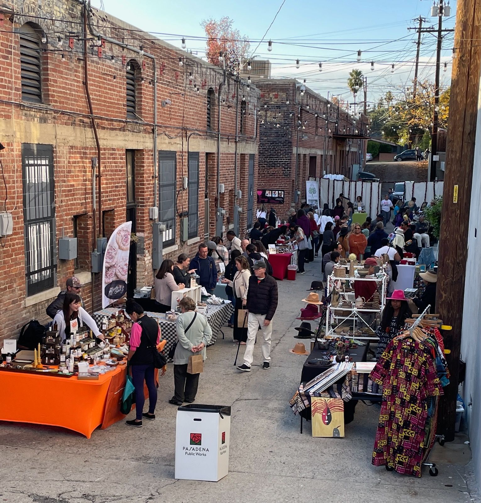 A group of people are gathered outside of a brick building