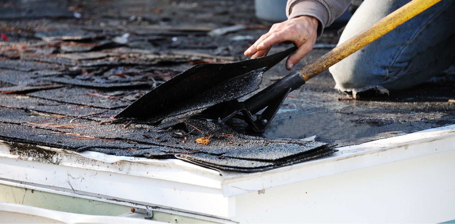 Removing worn asphalt shingles from an aging Miami Gardens roof